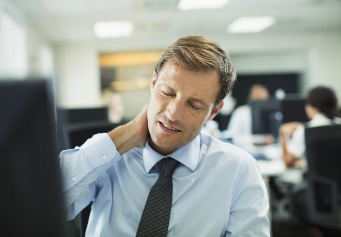 corporate guy having neck pain at work